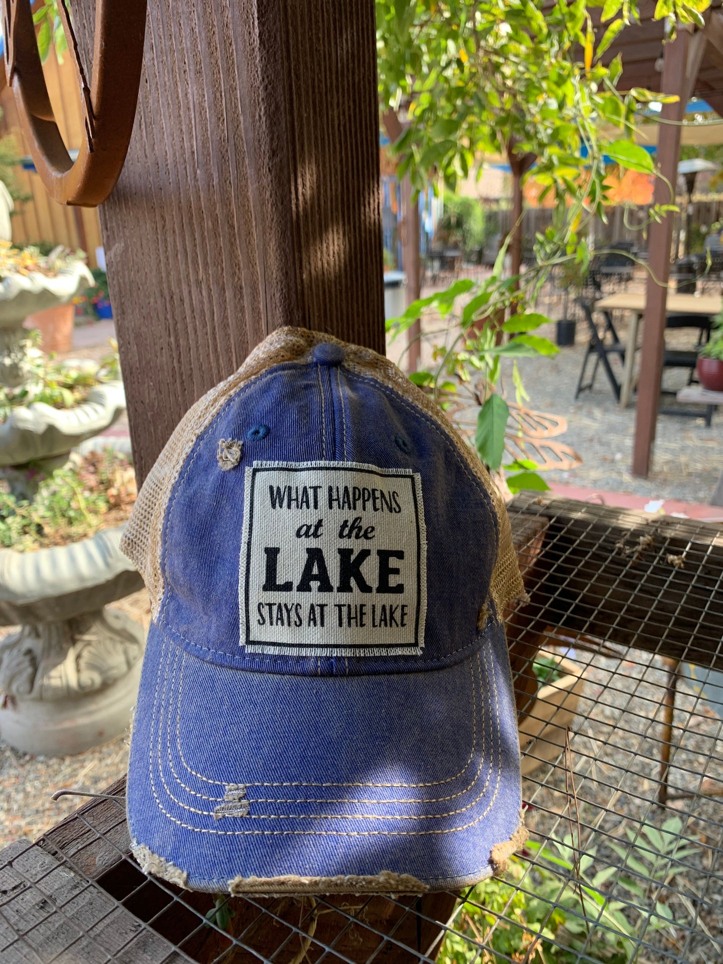 "What Happens At The Lake Stays At The Lake" Distressed Trucker Cap